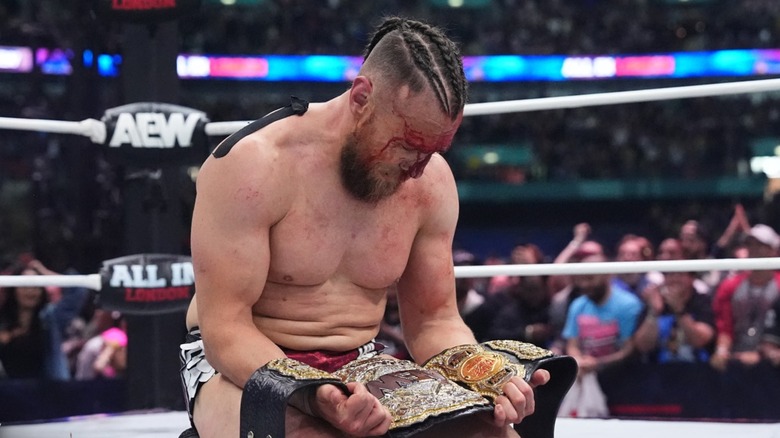 Bryan Danielson stares at his newly won AEW World Championship at All In: London 2024