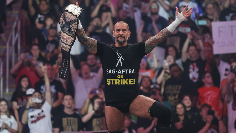 CM Punk poses in SAG-AFTRA shirt