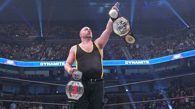 Eddie Kingston raising title belts
