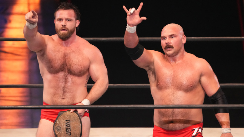 Cash Wheeler and Dax Harwood standing in a wrestling ring