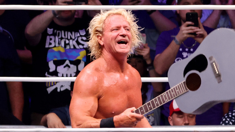 Jeff Jarrett holds up his guitar