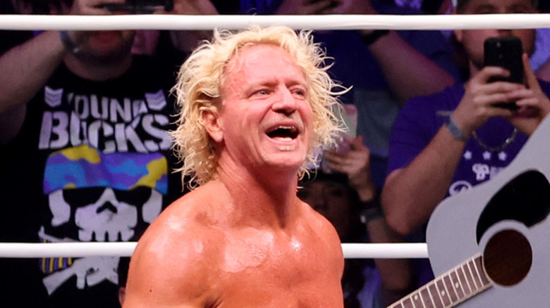 Jeff Jarrett looking please while holding a guitar