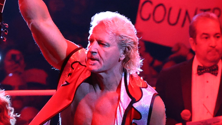 Jeff Jarrett holds up his guitar