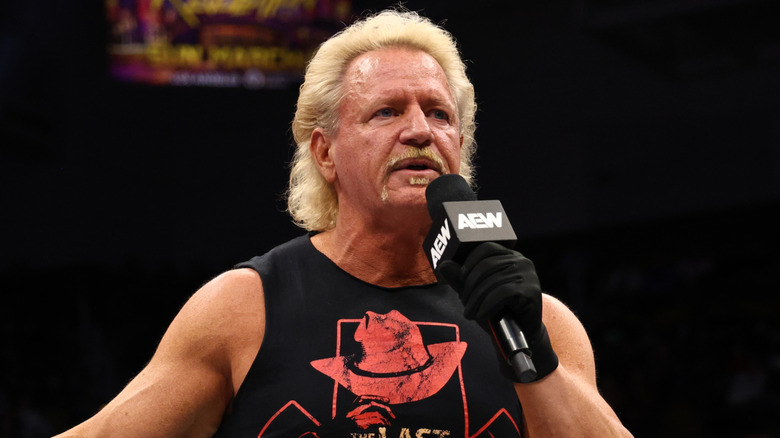 Jeff Jarrett holding a mic in an AEW ring