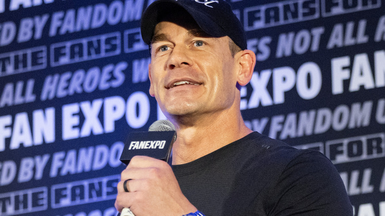 John Cena is holding a microphone