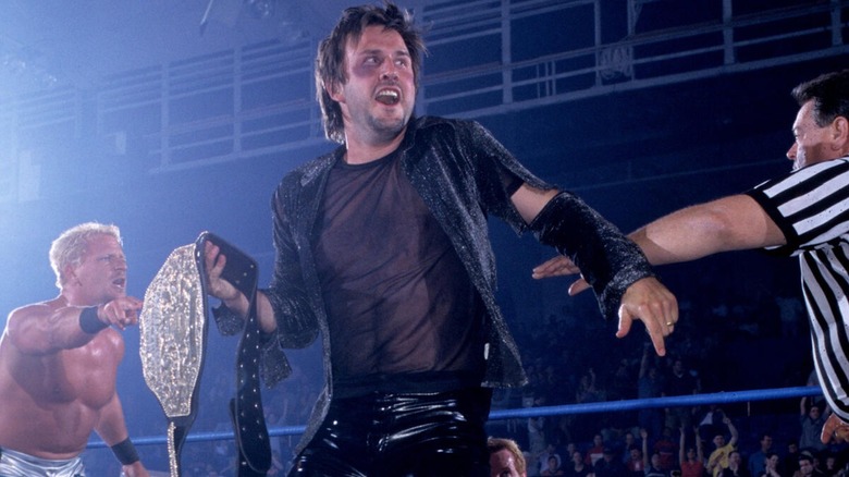 David Arquette after winning the WCW World Heavyweight Championship with Jeff Jarrett arguing the finish in the background.