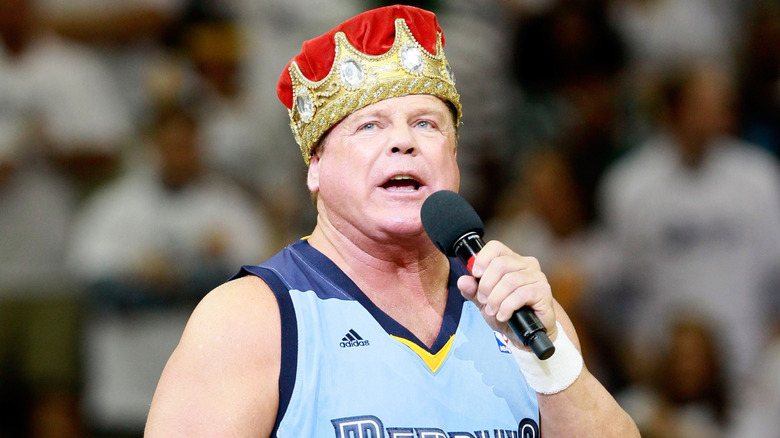 Jerry Lawler wearing a basketball jersey and a crown