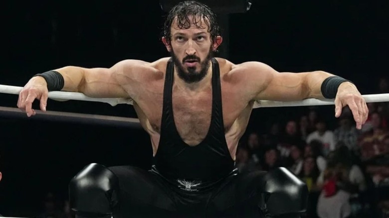 Pac leaning against the ring ropes