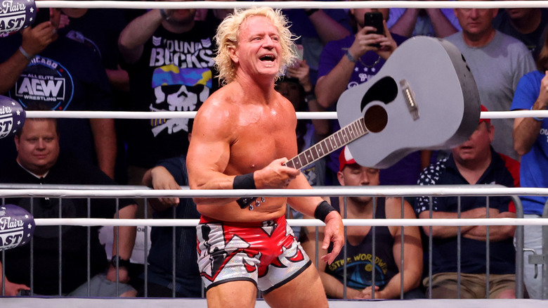 Jeff Jarrett holding a guitar in the ring