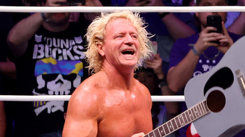 Jeff Jarrett holding up his guitar, yet again