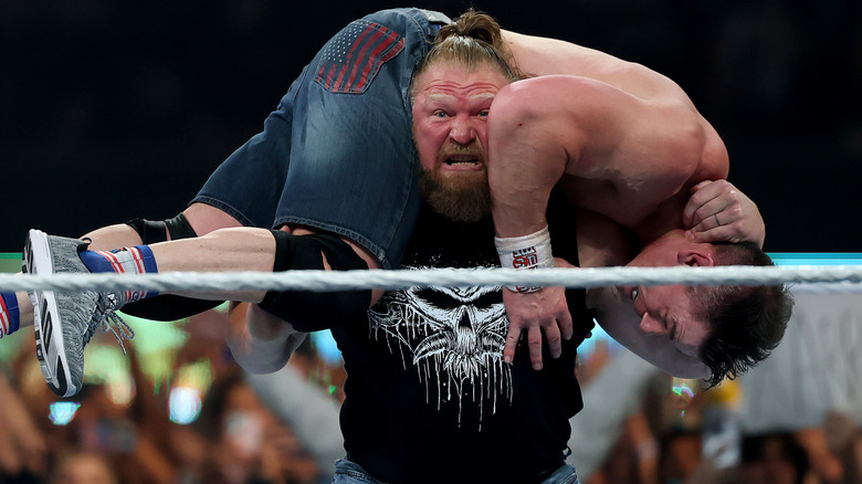 Brock Lesnar hoisting John Cena up to deliver an F5 during his WWE return at SummerSlam, 2025.
