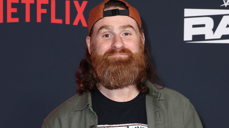 Sami Zayn wearing a backwards hat