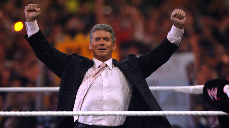 Vince McMahon takes in the crowds energy in the center of the ring