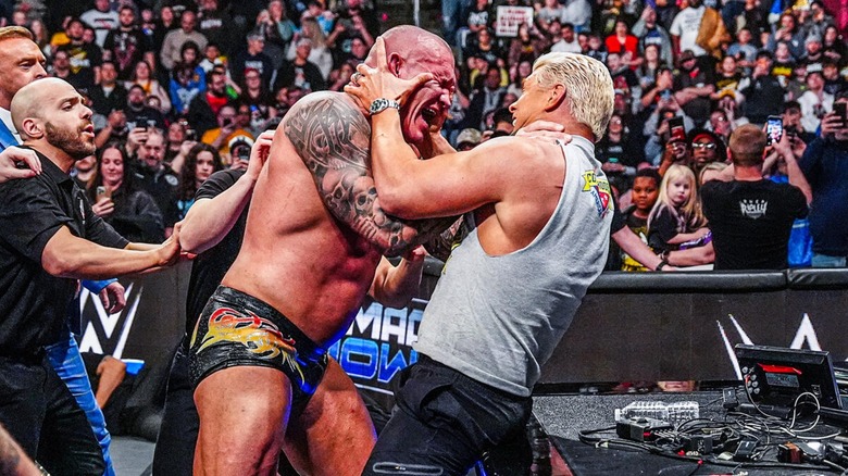 Randy Orton and Cody Rhodes getting into a heated ringside brawl during an episode of 