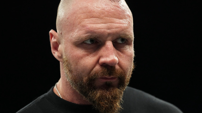 Jon Moxley stands in the ring and looks to the crowd during a promo on an episode of 