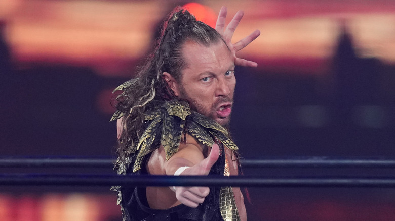 Kenny Omega doing his trademark finger gun taunt