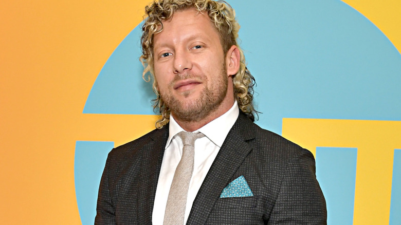 Kenny Omega wearing a suit