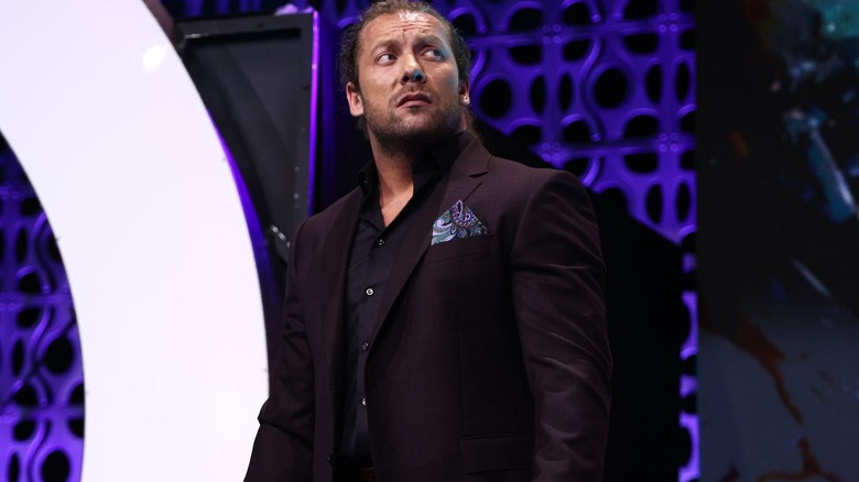 Kenny Omega looks pensively off to the side as he stands on the AEW entrance ramp.