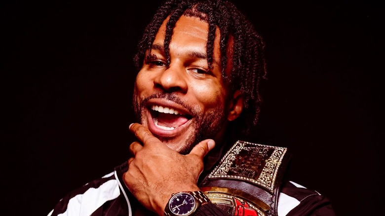 With a cheeky grin, Kevin Knight poses with his former TNT Championship during a backstage photo shoot