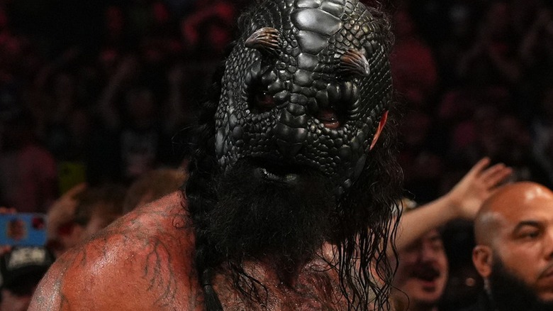 Luchasaurus at ringside looking on during an AEW show.