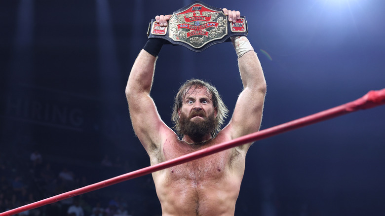 Mark Davis holds up his AEW National Championship in the ring following a victory on an episode of 