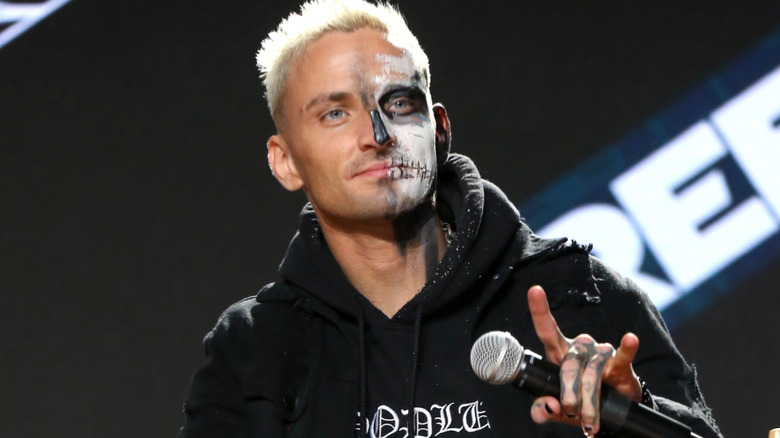 Darby Allin holding a microphone
