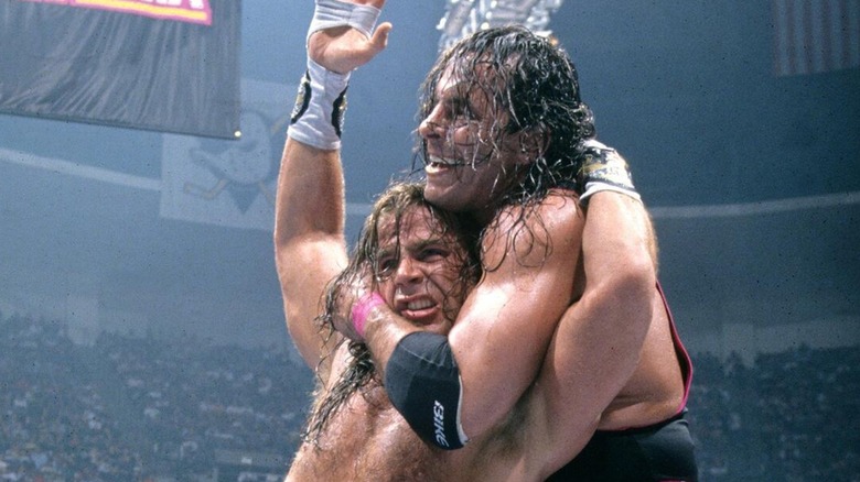 Bret Hart locking Shawn Michaels into a headlock mid-match.