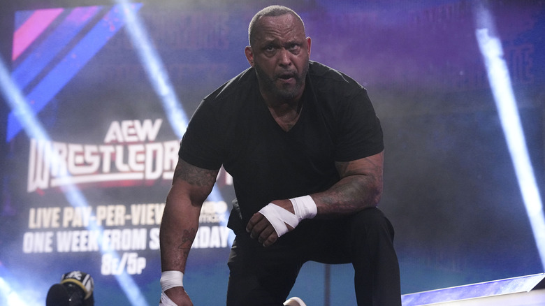 MVP crouches on the stage during a street fight alongside The Hurt Syndicate on an episode of "AEW Dynamite."