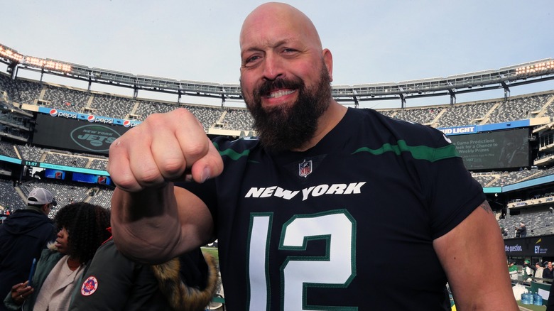 Paul Wight shows off his really big fist at a football game