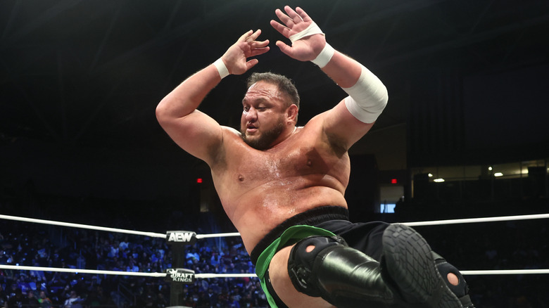 Samoa Joe delivering an elbow drop