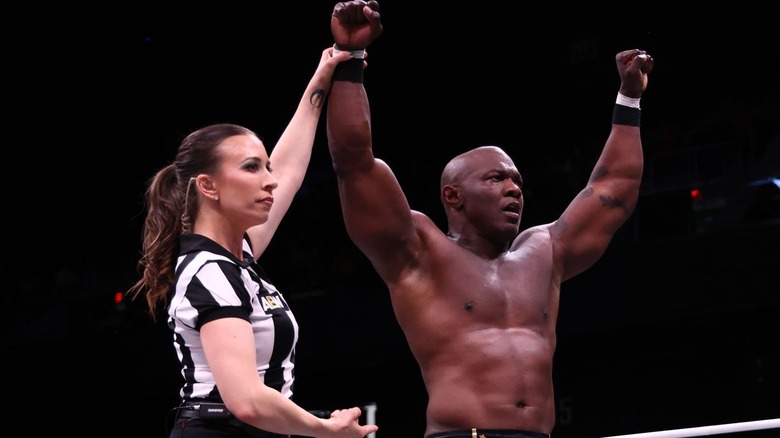 Shelton Benjamin with his hand raised in victory