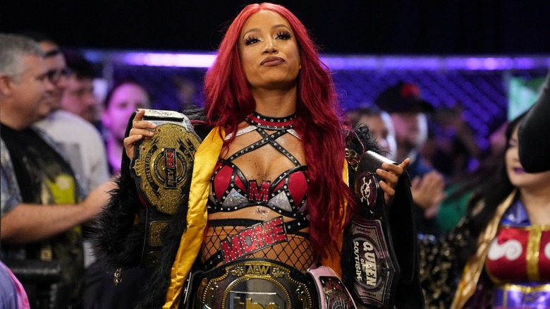 Mercedes Mone showing off all her championships during an episode of 
