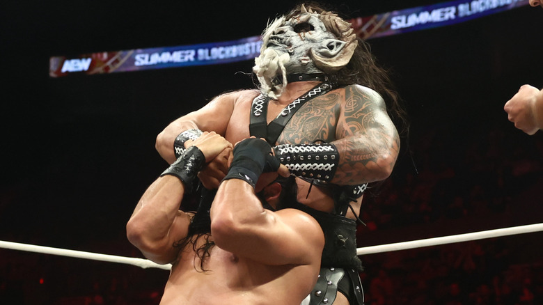 The Beast Mortos grabs Bandido by the eyes.