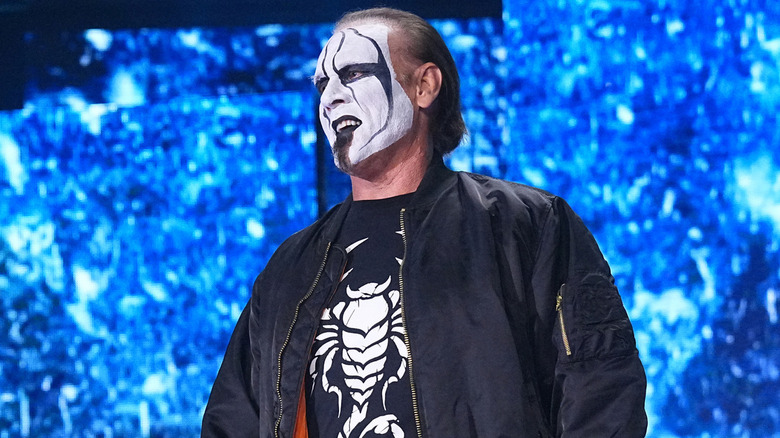 Sting wearing a black bomber jacket