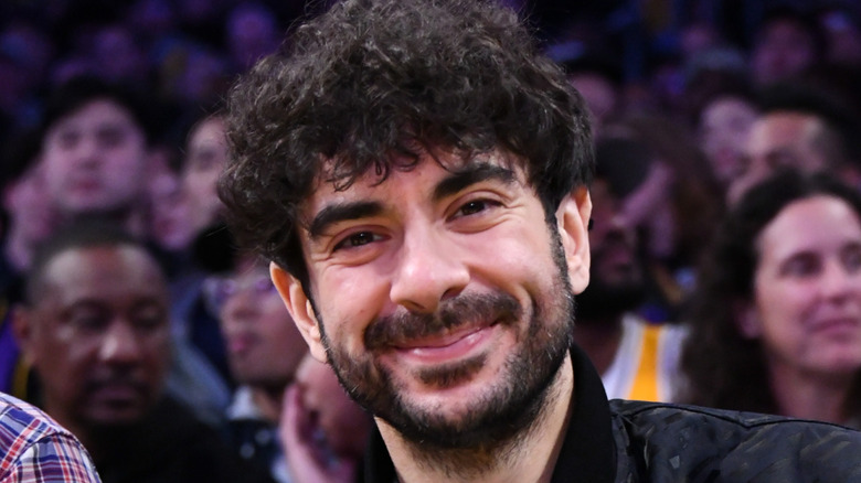 Tony Khan smiling at a sporting event