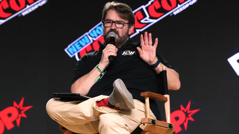 Tony Schiavone holding a microphone at a convention
