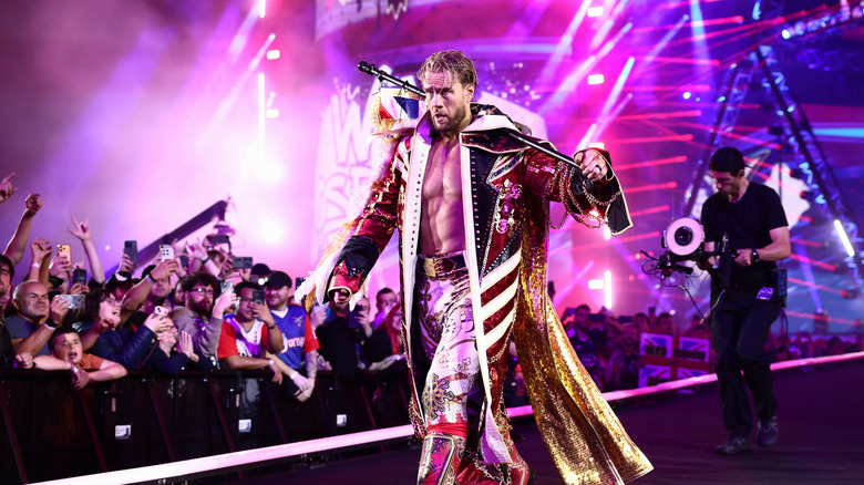 Will Ospreay walks to the ring, carrying the Union Jack flag across his back, before his AEW World Championship match at AEW All In 2026.