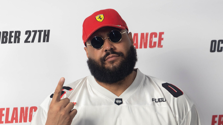 AJ Francis on the red carpet with a red hat