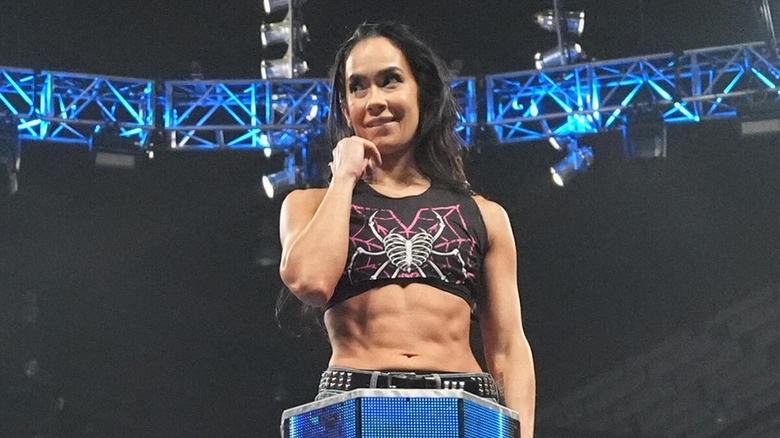 AJ Lee poses cutely as she perches herself on the middle rope.