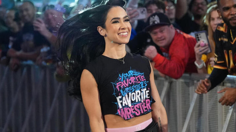 AJ Lee comes skipping down the entrance ramp as she sports a 