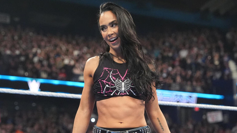 AJ Lee smiles as she looks off-screen.