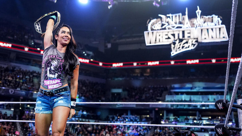AJ Lee holding up the IC title