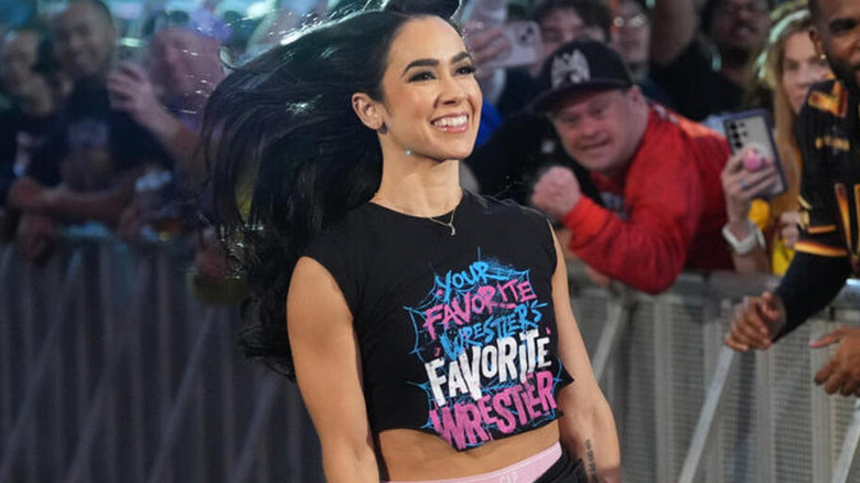 AJ Lee gleefully skips down the entrance ramp in a 
