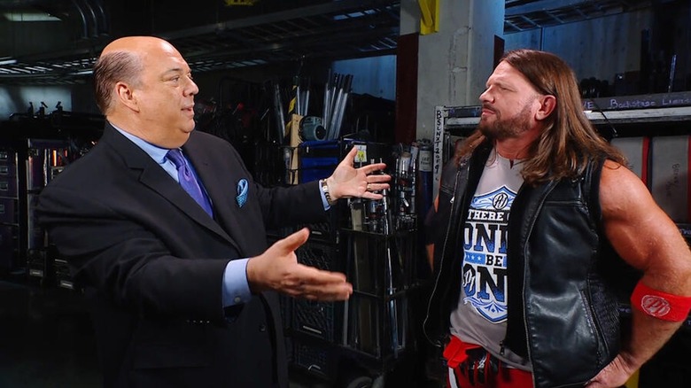 Paul Heyman and AJ Styles have a conversation backstage.