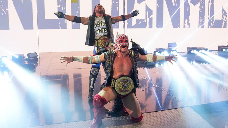 AJ Styles and Dragon Lee pose with their WWE World Tag Team Championships.
