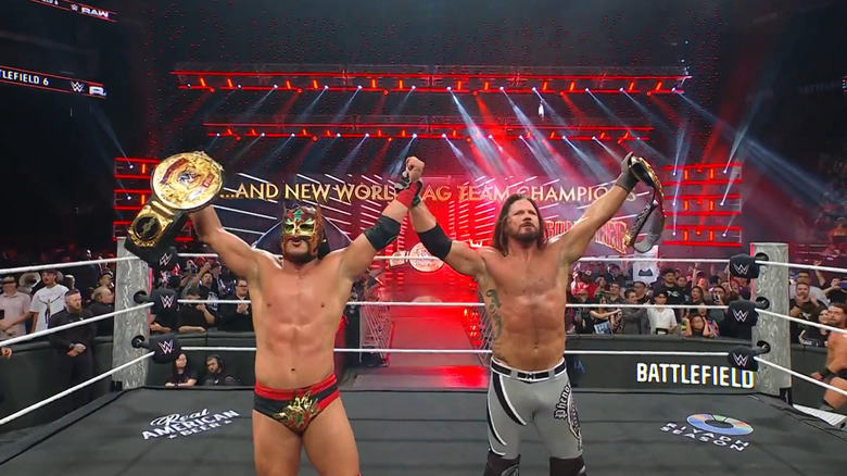 AJ Styles and Dragon Lee celebrate with the World Tag Team Championship