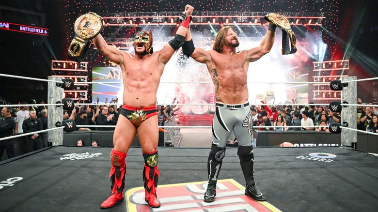 AJ Styles and Dragon Lee celebrate with the World Tag Team Championship