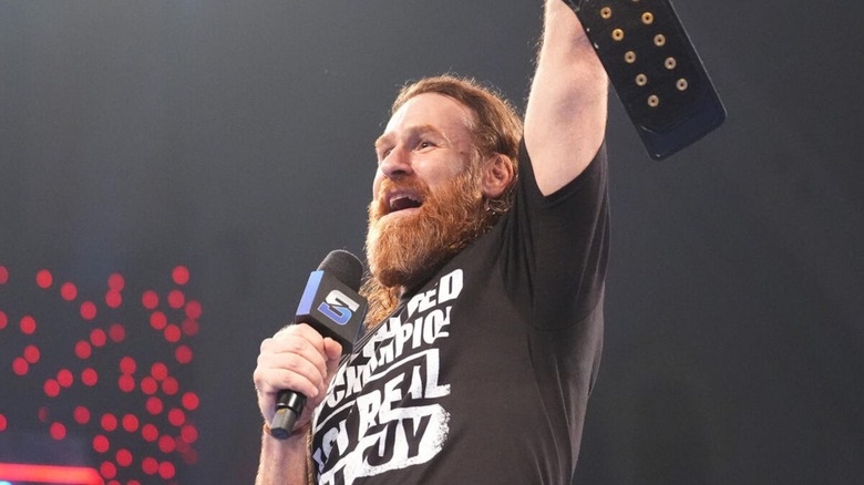 Undisputed WWE Champion Sami Zayn raises the title over his head during a victory celebration to open the July 3, 2026 edition of 
