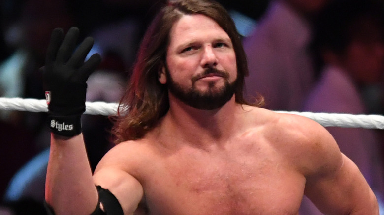 AJ Styles wearing a glove on his hand