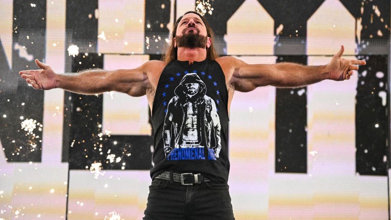 AJ Styles poses on the stage before a segment on WWE programming.